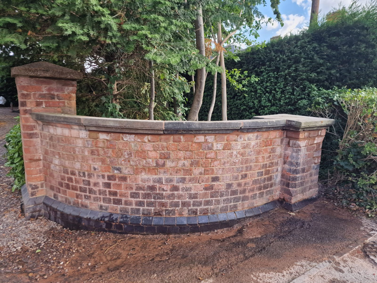 Completed curved brick wall restoration by Turner Building & Renovation