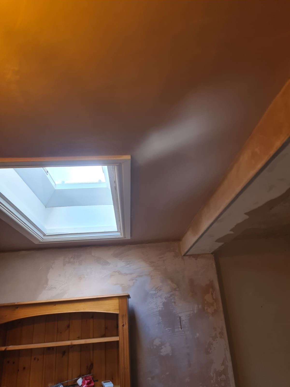 Fresh plaster around a rooflight and ceiling during renovation
