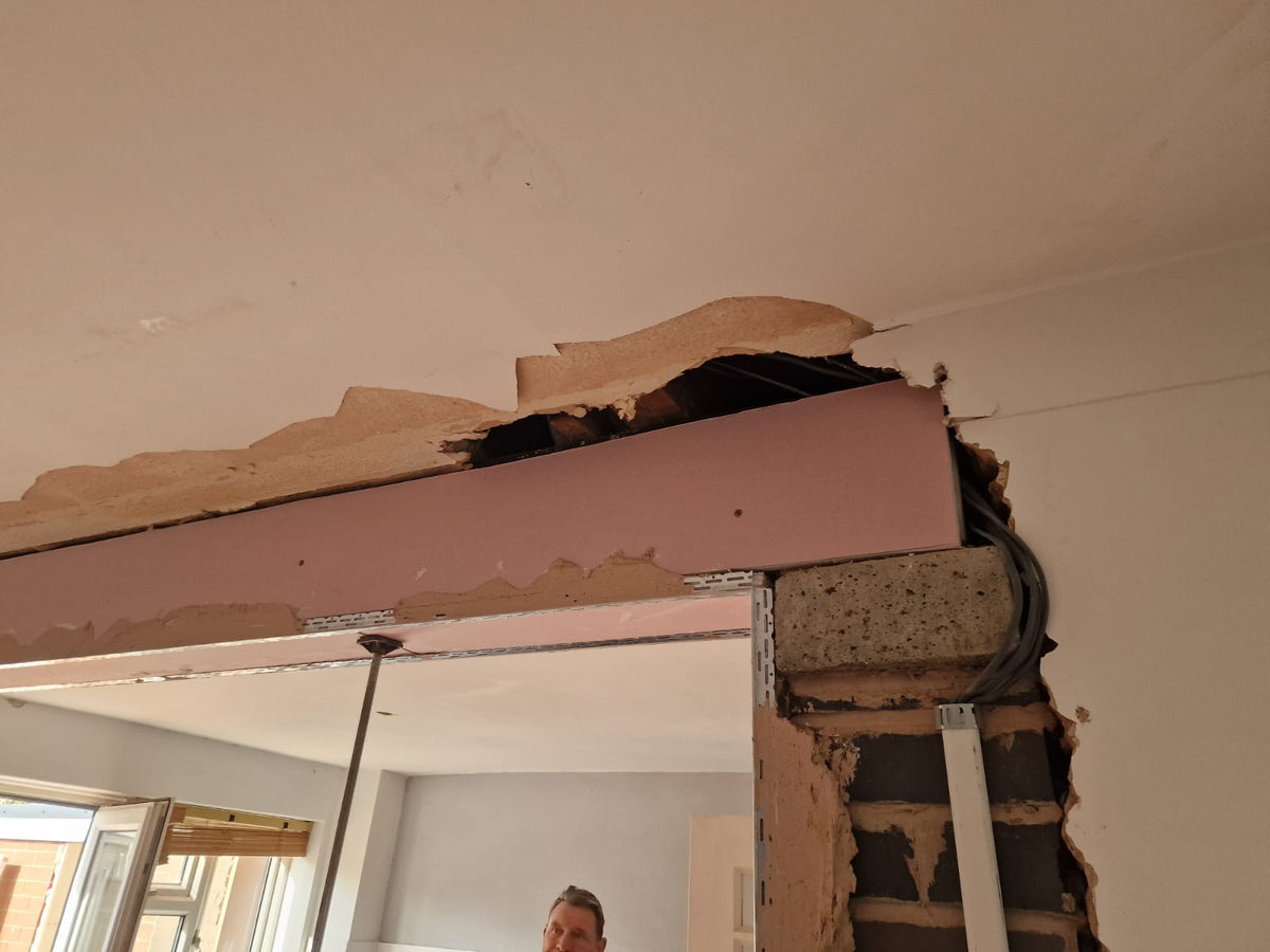 Structural opening with beam boarding and exposed masonry during Turner building work